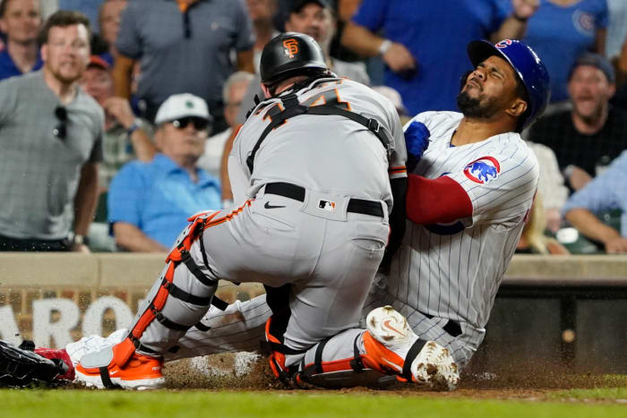 Chicago Cubs third baseman Jeimer Candelario collides with SF Giants catcher Patrick Bailey during the seventh inning at Wrigley Field on September 5, 2023.